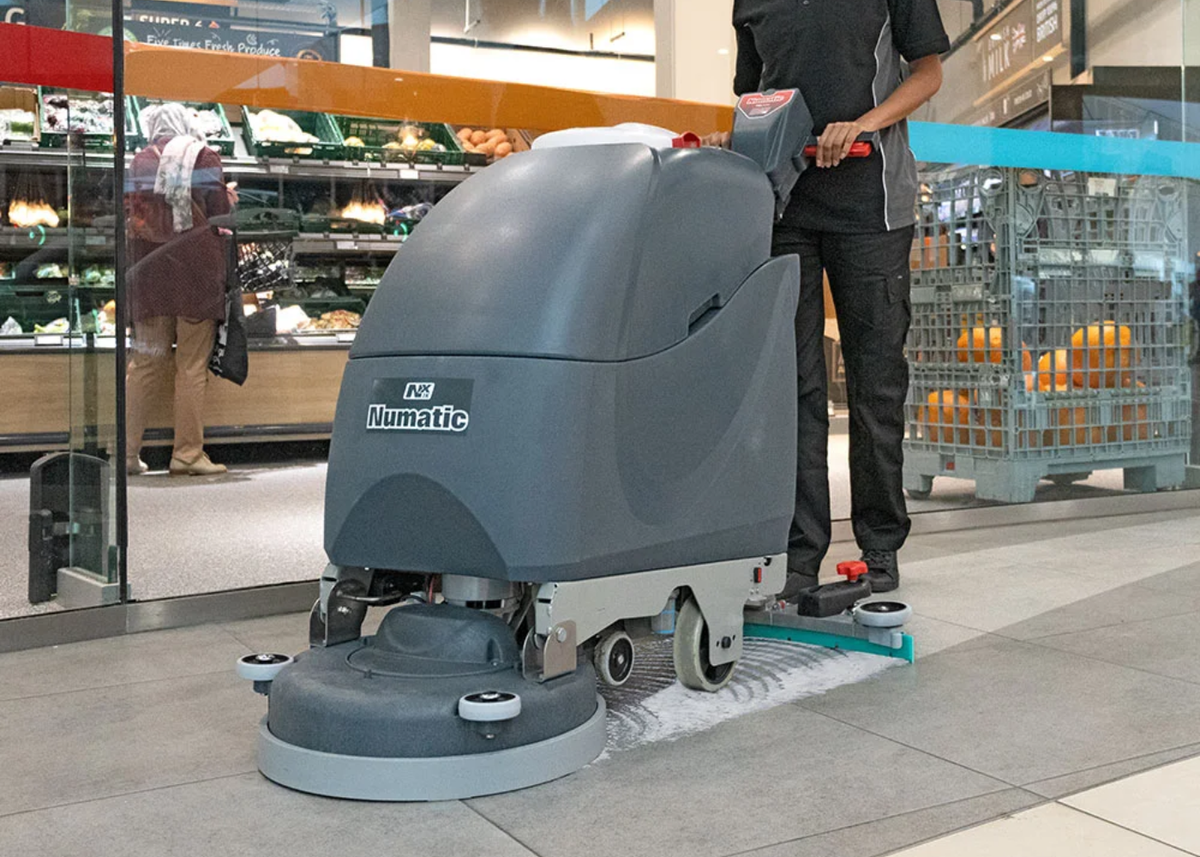 Heavy-duty industrial scrubber dryer cleaning a large commercial floor space, showcasing advanced floor washer technology from MK Floortec.