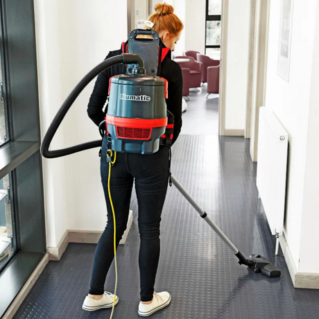 Numatic RSV150H backpack vacuum features ergonomic design, adjustable harness, and breathable mesh for comfort in tight spaces. 