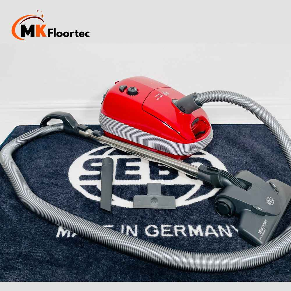 Sebo E1 Red +BOOST vacuum cleaner in vibrant red, featuring a Kombi Floor head for effective cleaning of hard floors and carpets. 