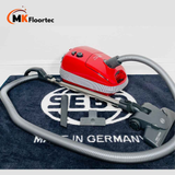 Sebo E1 Red +BOOST vacuum cleaner in vibrant red, featuring a Kombi Floor head for effective cleaning of hard floors and carpets. 